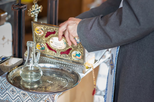 Tools for baby baptism. eley in the hands of a priest. Catholicism, the concept of Christianity