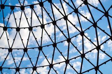 the blue sky through the pattern in the dome on an abandoned construction site