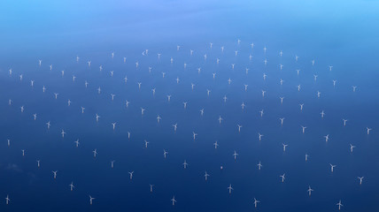 Windmills at the sea. Clean energy made by the wind.