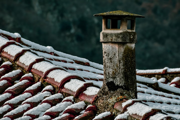 snowy vintage roof and chimney