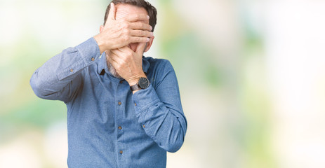 Handsome middle age elegant senior man over isolated background Covering eyes and mouth with hands, surprised and shocked. Hiding emotion