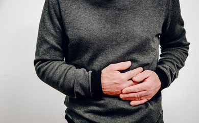 Abdominal pain, stomach problems. Medical and health concept. The man suffers from stomach pain,...