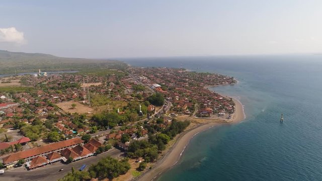 Aerial view coastal port city Gilimanuk place where ferry port for departure from Bali to the island of Java is located. Coastal city on the coast.