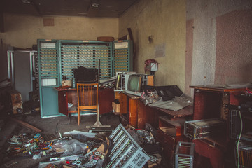 Switchgear cabinets with broken hardware in abandoned factory 