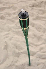 torch stands in the sand on the beach
