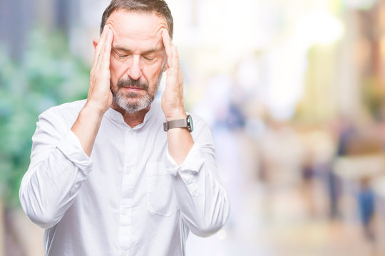 Middle age hoary senior man over isolated background with hand on head for pain in head because stress. Suffering migraine.
