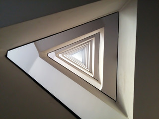 Minimalist triangle geometric infinite spiral pattern modern urban staircase abstract architecture...