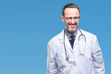 Middle age senior hoary doctor man wearing medical uniform isolated background winking looking at...