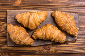 Croissants on wooden background