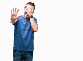 Fototapeta premium Middle age hoary senior man over isolated background covering eyes with hands and doing stop gesture with sad and fear expression. Embarrassed and negative concept.