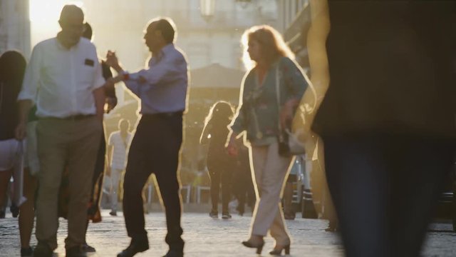 Slow motion of men walking and talking in busy city street / Lisbon, Lisboa, Portugal