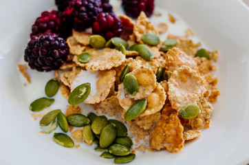 bowl of cereal and berries milk and nuts