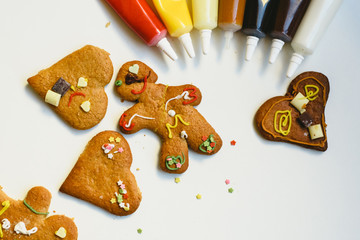 Preparing gingerbread cookies with colorful decorations.
