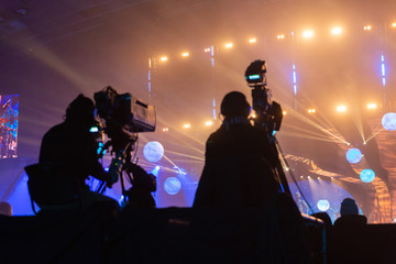 Silhouette of a group of cameramen broadcasting an event.