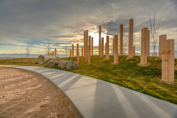 A sunset behind wooden pillars and playground