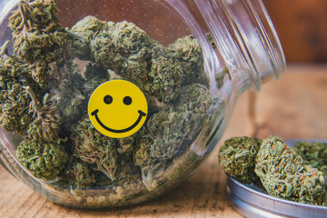Mango Kush Marijuana In Open Jar With Happy Face