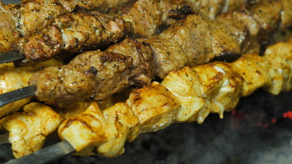 Skewers of white and red meat strung on a skewer grilled, close-up photo