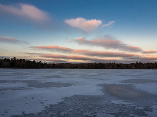 sunset over a frozen lake in winter