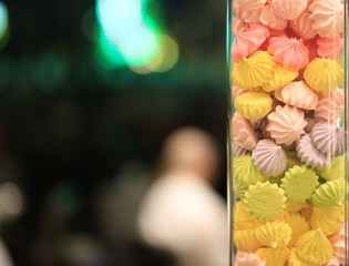 Colorful meringue in glass with copy space blurred background 