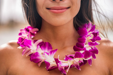 Lei hawaii welcome necklace of fresh orchids flowers garland on woman's neck. Aloha spirit. Hula dancer at luau beach party. - obrazy, fototapety, plakaty