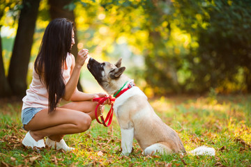 Portrait of pretty woman with her don in the park.