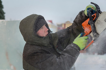 Portrait of an assembler with a chainsaw in his hands