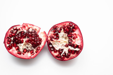 halved pomegranate isolated on white background