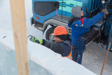 Fototapeta na wymiar Worker on the installation of an ice panel