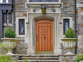 elegant wooden front door of stone house