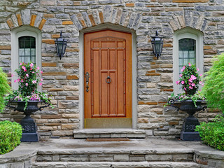 Fototapeta na wymiar elegant wooden front door of stone house