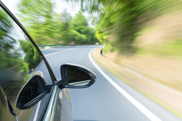 Fototapeta na wymiar car driving with fast motion blur