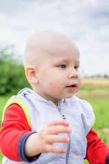 Portrait of a little boy close-up on a meadow.