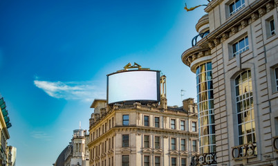 A large digital display board on top of a building in london near piccadilly