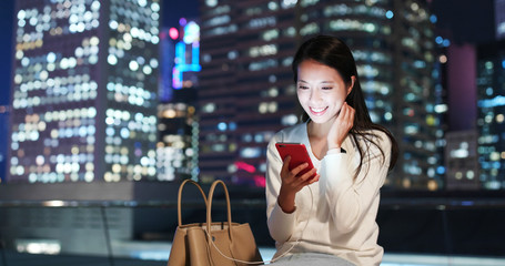 Woman use of smart phone in city