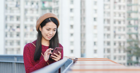 Fototapeta premium Woman check on mobile phone in city