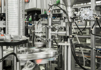 production and bottling of yogurt in plastic cups. equipment at the dairy plant