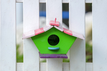 cute little birdhouses on rustic wooden fence