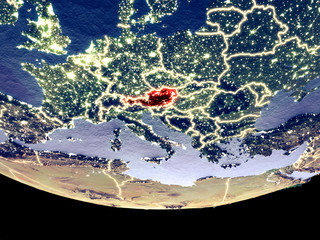 Satellite view of Austria from space at night. Beautifully detailed plastic planet surface with visible city lights.