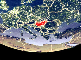 Satellite view of Hungary from space at night. Beautifully detailed plastic planet surface with visible city lights.