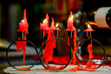 Red candles are burning. Candles for Valentine's Day. Background of the luminous scratches. fire...