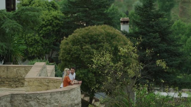 Couple relaxing and admiring scenic view at Jardines de Cuenca / Ronda, Malaga, Spain
