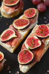 whole bread with cheese, parma ham and figs