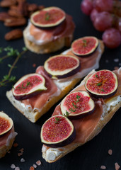 whole bread with cheese, parma ham and figs