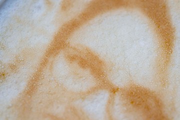Drawing of a woman's face on a foam coffee latte in a glass created by a 3D printer close-up. 3d printer created a portrait of a girl on the foam of brewed coffee