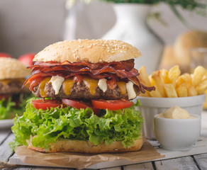 Homemade bacon burger with lettuce and cheddar