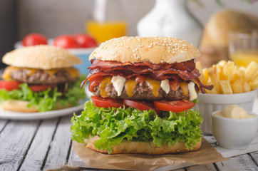 Homemade bacon burger with lettuce and cheddar