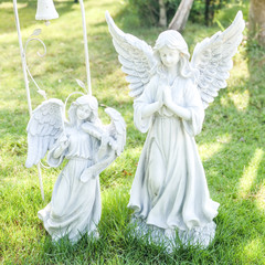 Statue of a young angel in the garden
