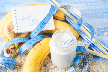 Banana smoothie with honey and oats on a wooden table.