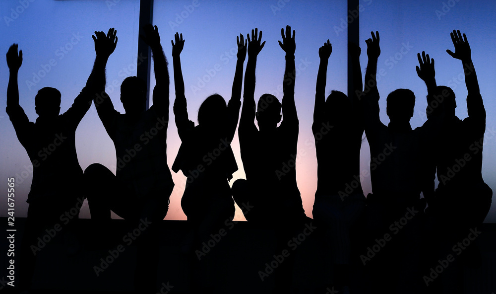 Wall mural group of positive young people sitting on a windowsill.