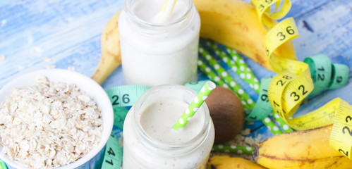 kiwi Banana smoothie with honey and oats on a wooden table.